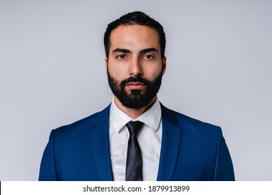 Serious successful Arabian businessman in formal attire isolated over grey background - Shutterstock ID 1879913899