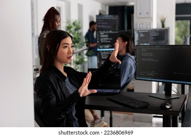 Serious system engineer working with hologram and coding language in programming software company. Analyzing holographic html script and augmented reality to develop new server interface. - Powered by Shutterstock