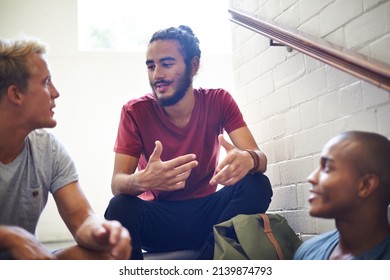 Serious talk between bros. Shot of male university students sitting and talking before class. - Powered by Shutterstock