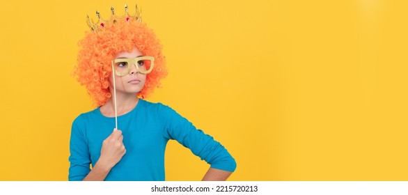 Serious Teen Girl In Fancy Clown Wig Wear Queen Crown And Funny Party Glasses, Arrogant. Funny Teenager Child In Wig, Party Poster. Banner Header, Copy Space.