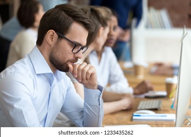 Serious thoughtful focused businessman thinking about business strategy, economic report, future, new opportunity at workplace, doing difficult work, planning, tired overworked employee - Shutterstock ID 1233435262