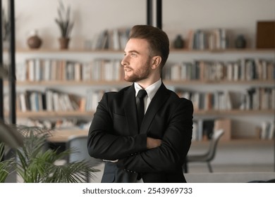 Serious thoughtful handsome company leader man in formal suit posing in co-working space with bookshelves, looking at window away in deep thoughts, planning project, thinking on successful business - Powered by Shutterstock