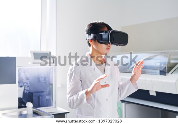 Serious Thoughtful Young Asian Laboratory Scientist Stock Photo