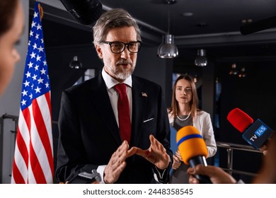 Serious United States Presidential Candidate answers journalists questions, gives interview for media and TV news in government building. American politician during press conference. Political speech. - Powered by Shutterstock