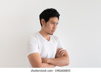 Serious And Upset Asian Man Wears White T-shirt Isolated On White Background.