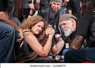 Serious Woman In Arm Wrestling Contest With Biker Gang