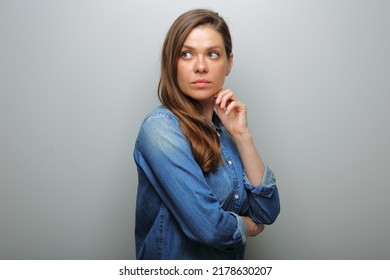 Serious Woman In Blue Casual Denim Shirt Looking Over Shoulder. Isolated Female Portrait.