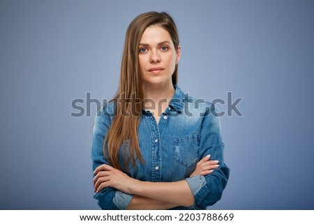 Serious woman in blue casual denim shirt isolated portrait.
