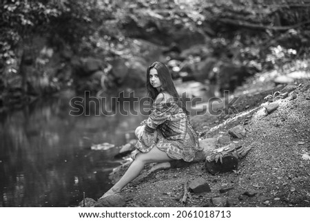 Similar – beautiful brunette short hair girl leaning on gray rock wall outdoors smiling happy