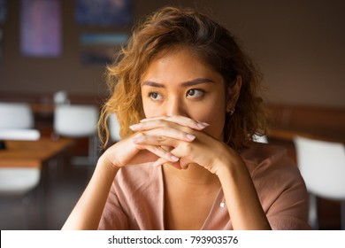 Serious Woman Covering Mouth with Clasped Hands - Shutterstock ID 793903576