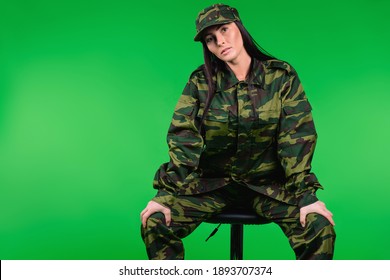 A Serious Woman In A Military Uniform On A Black Chair Looks At The Camera. Gender Equality, Caucasian Female Soldieer, Gender Stereotypes