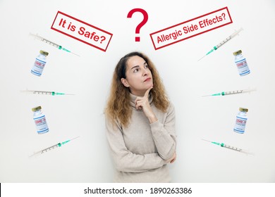 A serious woman with questions and doubts with covid-19 vaccine bottles and It is Safe and Allegic Side Effects signs. - Shutterstock ID 1890263386