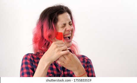 Serious Woman Tearing Red Tape From Her Mouth And Screaming In Pain Over White Background. Prohibition Of Freedom Of Speech. Silence. 