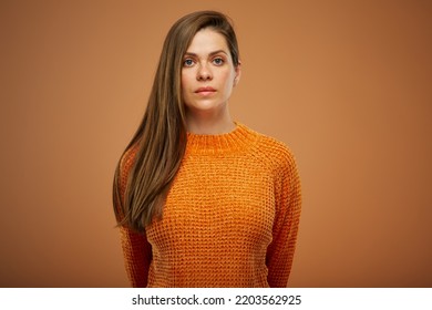 Serious Woman With Unemotional Face Isolated Portrait On Orange Background.