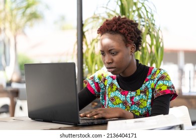 Serious Young African Girl Sitting At Her Laptop And Looking For A Job On The Internet; Social Problem Of Youth Unemployment In Developing Countries