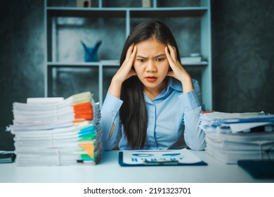 Serious Young Asian Female Business Overtime Work At Desk In Office At Night.