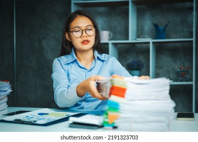 Serious Young Asian Female Business Overtime Work At Desk In Office At Night.