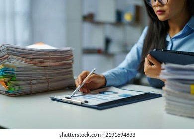 Serious Young Asian Female Business Overtime Work At Desk In Office At Night.