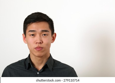 Serious Young Asian Man Looking At Camera.