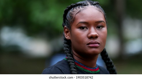 Serious young black woman Portrait African girl outside