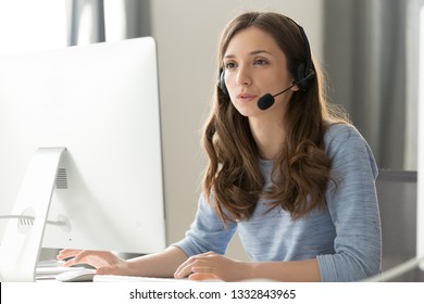 Serious Young Businesswoman In Wireless Headset Call Center Agent Telemarketer Consulting Client Participating Business Video Conference Talk Help As Customer Care Service Support Helpline In Office