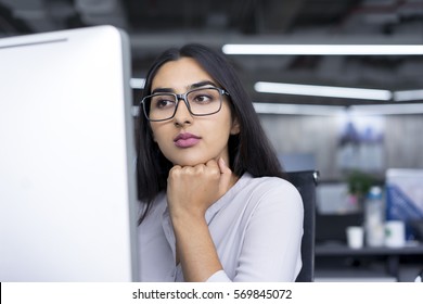 Serious Young Businesswoman Working At Computer