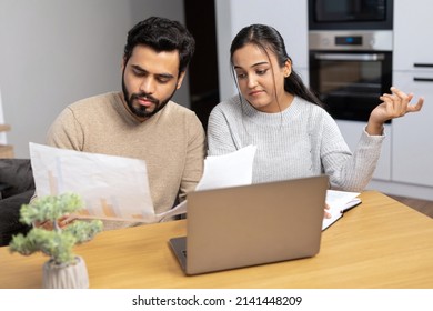 Serious Young Couple Study Documents Together, Have Serious Looks, Dressed In Casual Wear, Plan Their Budget, Pose In Spacious Light Room, Do Paperwork, Busy Preparing Financial Report