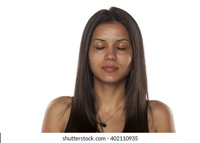 Serious Young Dark-skinned Pretty Woman Without Makeup With Closed Eyes