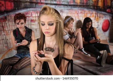 Serious young European girl looking at her phone