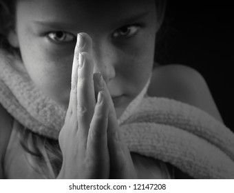 Serious Young Girl With Hands Poised For Prayer