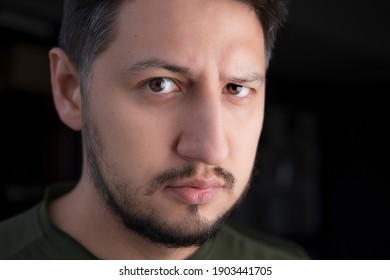 A Serious Young Man With Furrowed Brows Close Up