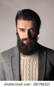 Serious Young Man With A Long Beard Posing In The Studio