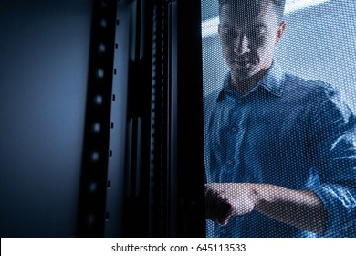 Serious young man working in the server room