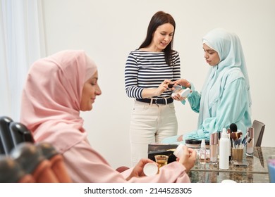 Serious Young Muslim Woman Choosing Suitable Cosmetics