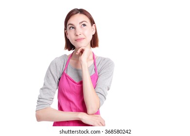 Serious young woman housewife think and look something and she is wearing Kitchen Apron isolated Over White Background