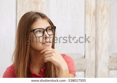 Image, Stock Photo Rectangular portrait of a young woman in front of a green wall