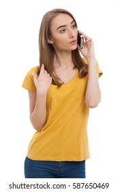 Serious Young Woman Talking On Phone Isolated On White. Copy Space And Fashion. Mock Up. Yellow T-shirt.