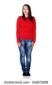 Serious Young Woman Wearing Red Blouse And Jeans Is Standing Straight. Isolated On White Background.