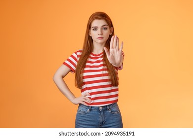 Serious-looking confident brave redhead girl oppose haters, fighting for freedom, prohibit illegal actions, extend hand stop enough, never or forbidden gesture, look determined camera - Shutterstock ID 2094935191