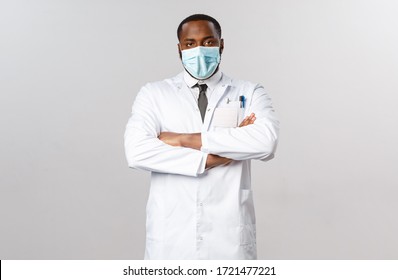 Serious-looking Disappointed African-american Doctor Looking Skeptical And Tired At Person Not Following Covid-19 Quarantine Recommendations, Cross Arms Chest, Staring Camera, Wear White Coat