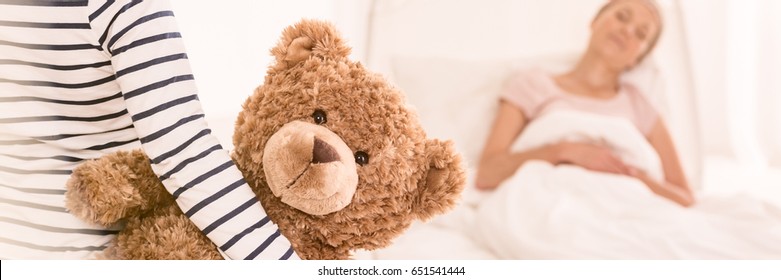 Seriously Ill Woman On Bed With Young Girl