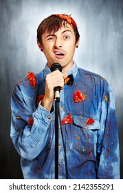 Seriously Unfunny. Portrait Of An Unsuccessful Standup Comedian Covered In Rotten Tomatoes.