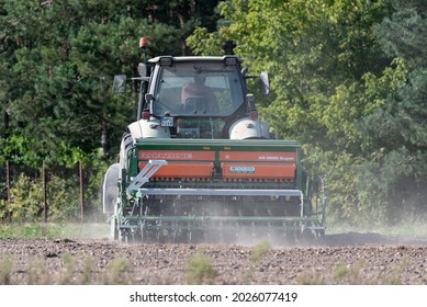 Serock, Poland - September 14, 2020: Tractor With Grain Seeder In The Field. Sowing Grain In The Field, Cultivating Cereals.