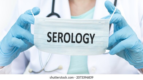 Serology Inscription On The Protective Mask In The Hands Of A Doctor