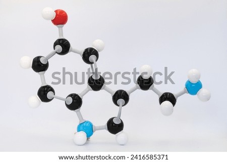 Serotonin (or 5-hydroxytryptamine) molecule made by molecular model on white background. Chemical formula with colored atoms and bonds