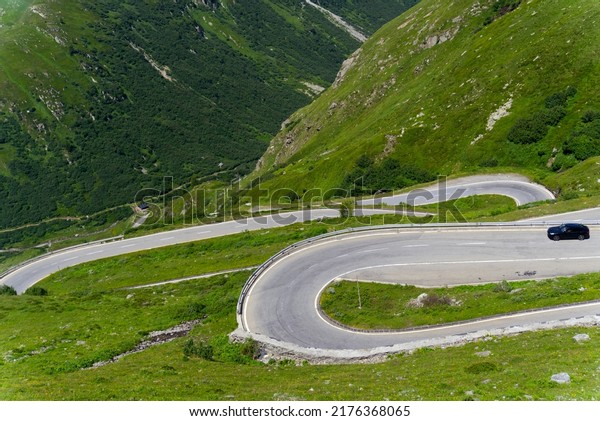 Serpentine mountain pass road of Nufenen\
Pass in the Swiss Alps on a sunny summer day. Photo taken July 3rd,\
2022, Nufenen Pass,\
Switzerland.
