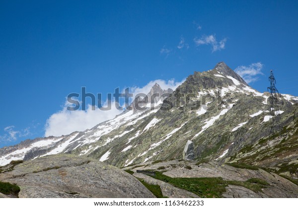 Serpentine road connectine alpine passes Furka\
and Grimsel