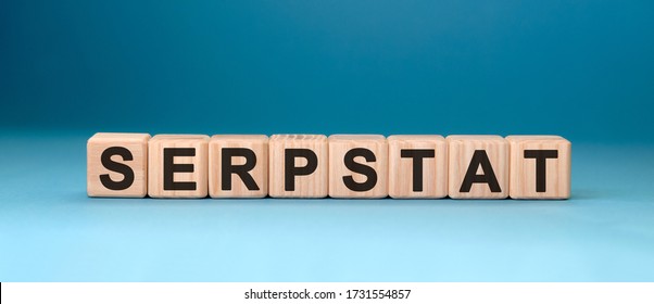 Serpstat - text concept on wooden cubes with gradient blue background