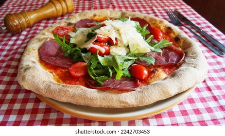 Serrano ham pizza. Neapolitan pizza made with baked vegetables and serrano ham. Italian vegetarian recipe. - Shutterstock ID 2242703453