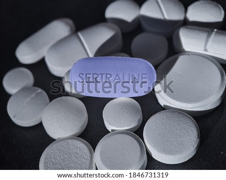 Sertraline blue pill antidepressant of selective serotonin reuptake inhibitor used to treat depressive disorder, OCD, panic disorder, PTSD, premenstrual dysphoric disorder Stock photo © 